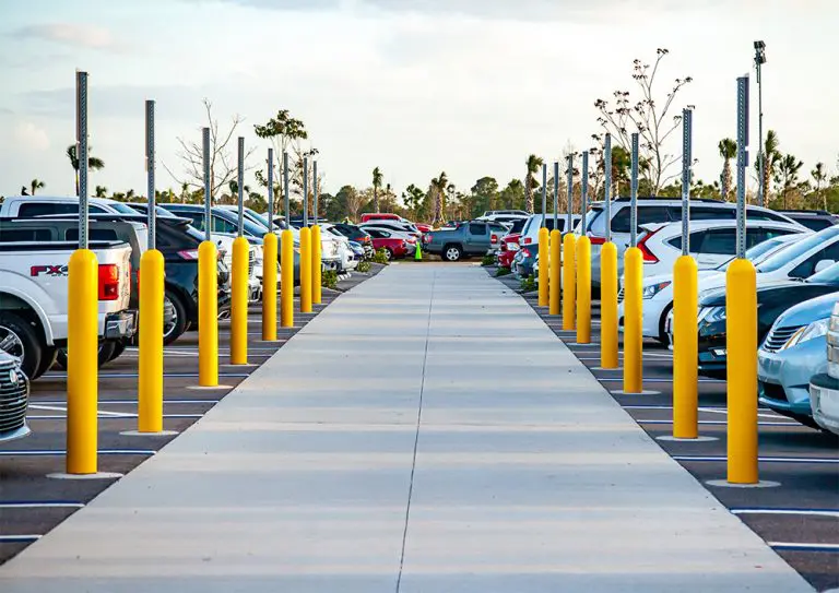 Professional parking lot with clear yellow bollards and striping